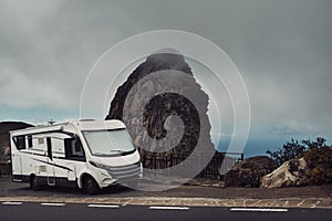 Modern camper van motor home parked on the road with amazing scenic landscape view. Concept of travel and vacation. Exploring