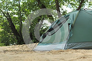 Modern camping tent near trees