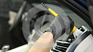Modern car cleaning worker wiping the dashboard. Car dry cleaning. Dashboard cleaning.