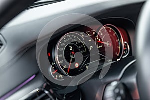 Modern car dashboard. New car interior details. Speedometer and tachometer. Selective focus.