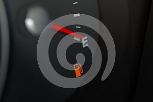 Modern car fuel gauge showing empty tank.