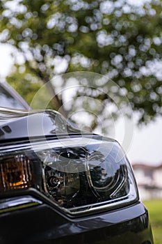 Modern car headlight close up photo