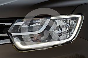 Modern car headlight close up view.