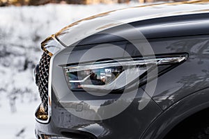 Modern car headlight close up view.