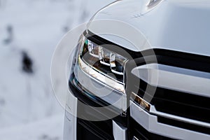 Modern car headlight close up view.