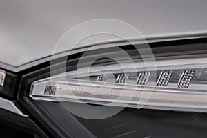 Modern car headlight close up view.