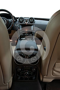 Modern car inside. Panel with two zone climate control buttons. View from the back seat.