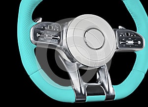 Modern car interior. Blue steering wheel with media phone control buttons isolated on black background. Car interior details. Car