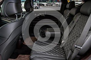 Modern car interior. Clean rear seats with the belts.