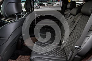 Modern car interior. Clean rear seats with the belts.