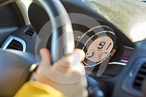 Modern car interior with driver hand on steering wheel. Safe driving concept