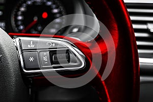 Modern car interior. Red Steering wheel with media phone control buttons, navigation multimedia system background. Car interior de photo