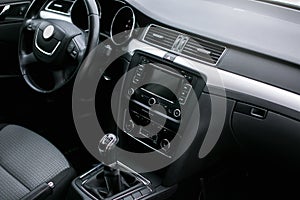 Modern car interior. Steering wheel, dashboard, speedometer, display.