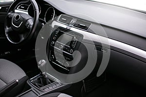 Modern car interior. Steering wheel, dashboard, speedometer, display.