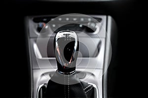 Modern car interior: steering wheel, gearshift lever, multimedia system. Manual transmission driving. Car gearbox lever.
