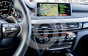 Modern car interior, steering wheel with media phone control buttons, navigation, screen multimedia system background,