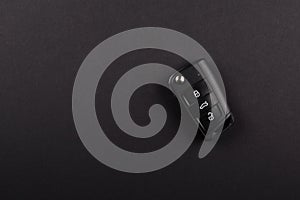 Modern Car Keys, with three electronic remote buttons, Folded.isolated on black background.