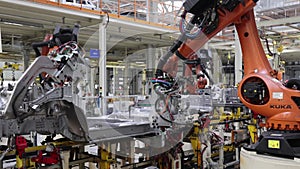 modern car plant, high-precision welding by robots, close-up