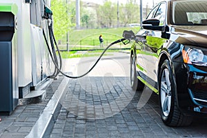 Modern car refueling with benzine on gas station