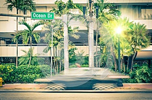 Modern car speeding along Ocean Drive in Miami