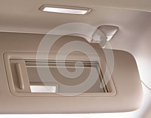 Modern car sun visor with mirror, close-up. Sunshield