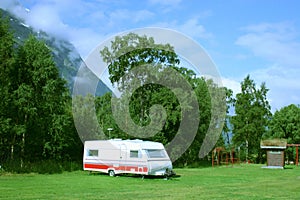 Modern caravan at the campsite in the mountains photo