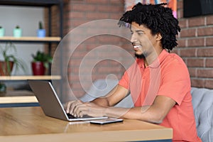 Modern Career. Black Freelancer Guy Working With Laptop At Table In Cafe