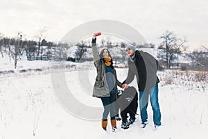 Modern carefree man and woman making selfie with their fluffy do