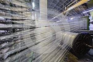 Modern Carpet weaving factory. Carpet making machine needle. Yarn bobbins attached to a carpet weaving machine. Inside Interior of