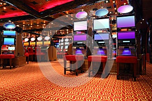 Modern casino hall with game machines photo
