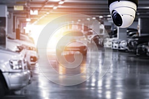 Modern of CCTV camera for monitoring surveillance and security on the wall with car park background photo