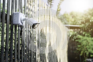 Modern CCTV security system on the background of a wooden wall in the garden. Smart camera theft protection