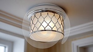 Modern ceiling light fixture with a chrome and pattern design.