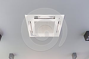 Modern ceiling mounted cassette type air conditioning system in coffee shop