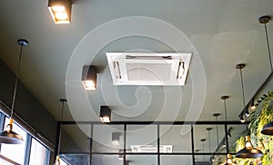 Modern ceiling mounted cassette type air conditioning system in coffee shop