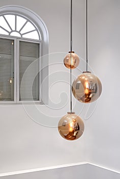 Modern ceiling round glass chandelier with arch wooden window inside of white living room in vertical frame