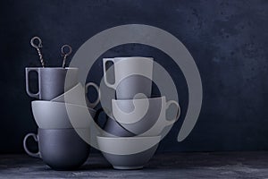 Modern ceramic dinnerware. Black ang grey cups, bowls