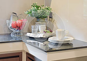 Modern ceramic kitchenware and utensils on the black counter top