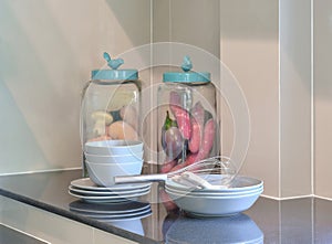 Modern ceramic kitchenware and utensils on the black counter top