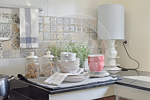 Modern ceramic kitchenware and utensils on the black counter top