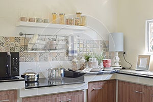 Modern ceramic kitchenware and utensils on the black granite counter top