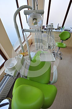 Modern chair and tools in dentists office photo