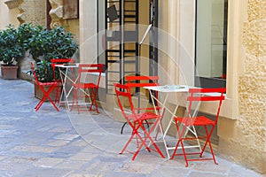 Modern chairs tables cafe terrace street, historic Lecce, Puglia, Italy