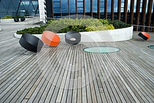 Modern chairs on the wooden public terrace