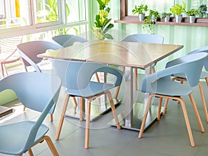 Modern chairs and wooden table in cafe