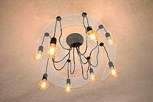 Modern chandeliers with Edison light bulb on the ceiling. Modern chandeliers on ceiling