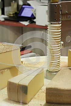 At modern cheese monger with high tech cheese cutting equipment photo