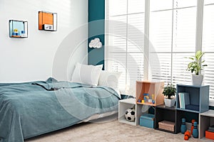 Modern child room interior with bed near window