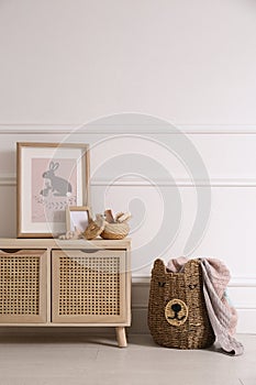 Modern child room interior with wooden cabinet and different accessories. Space for text