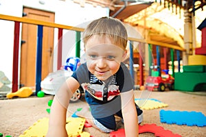 A modern children playground indoor. Boy playing on the playground.